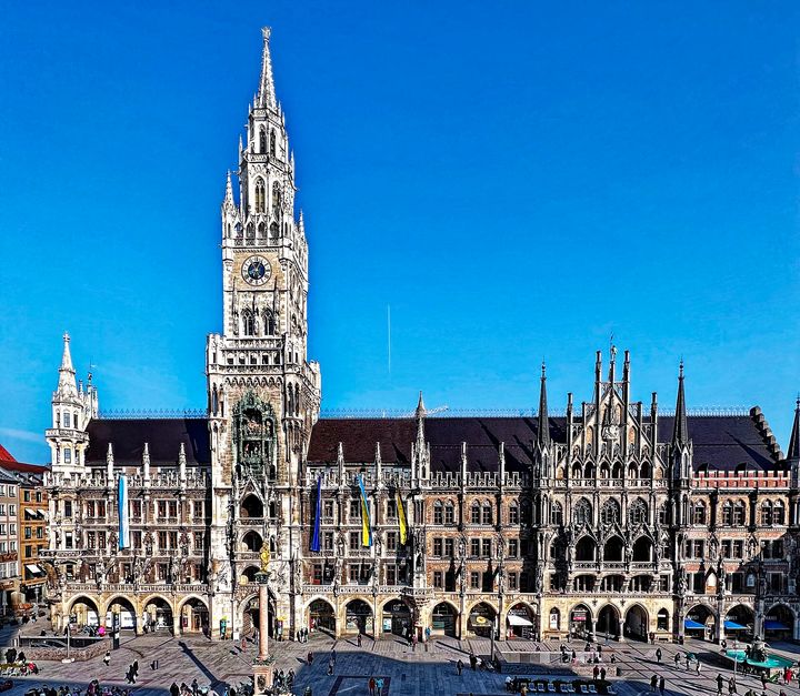 The New Town Hall on Marienplatz, with its tall clock tower, under a clear blue sky.